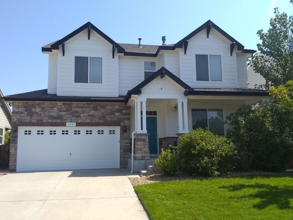 Exterior of white, two-story home with black trim