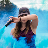 Customer profile image: woman waving blue smoke