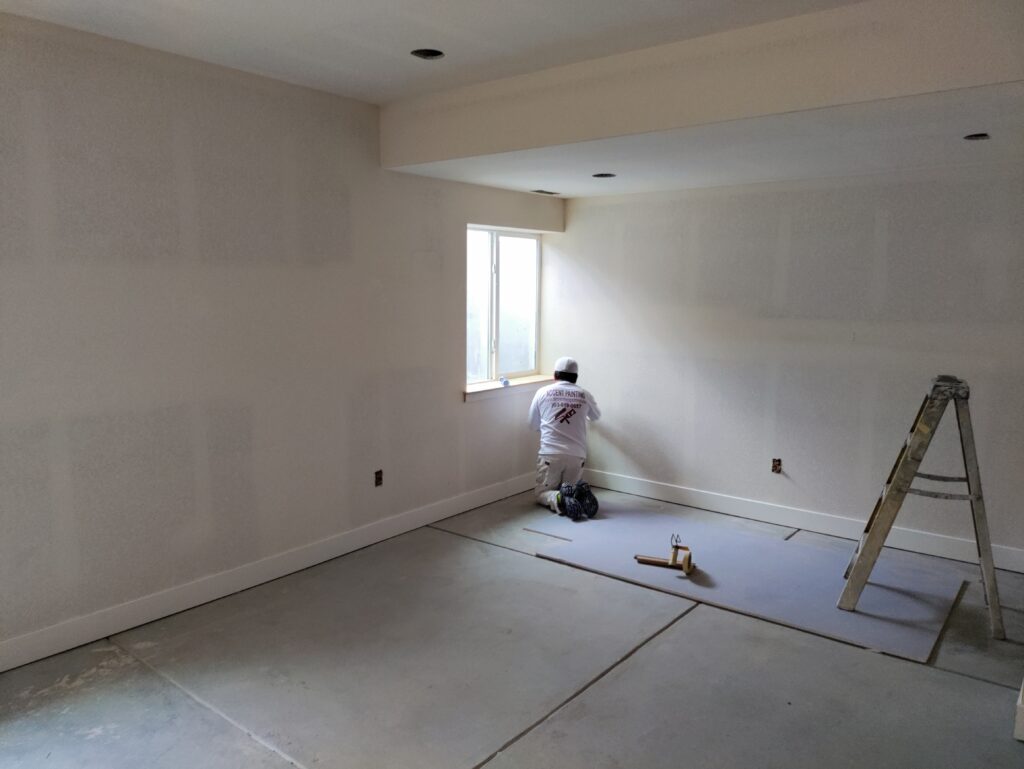 Finished walls and Accent Painting company crew member preparing for paint