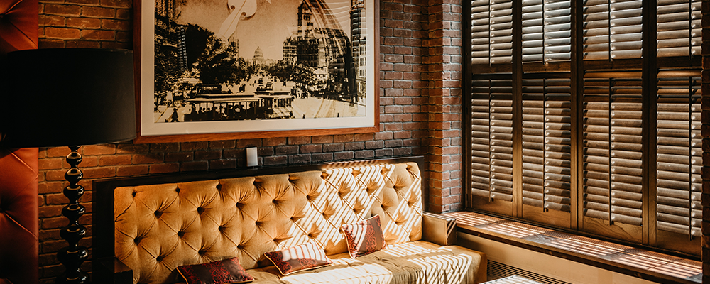 Rich, dimly lit home interior with exposed brick accent wall