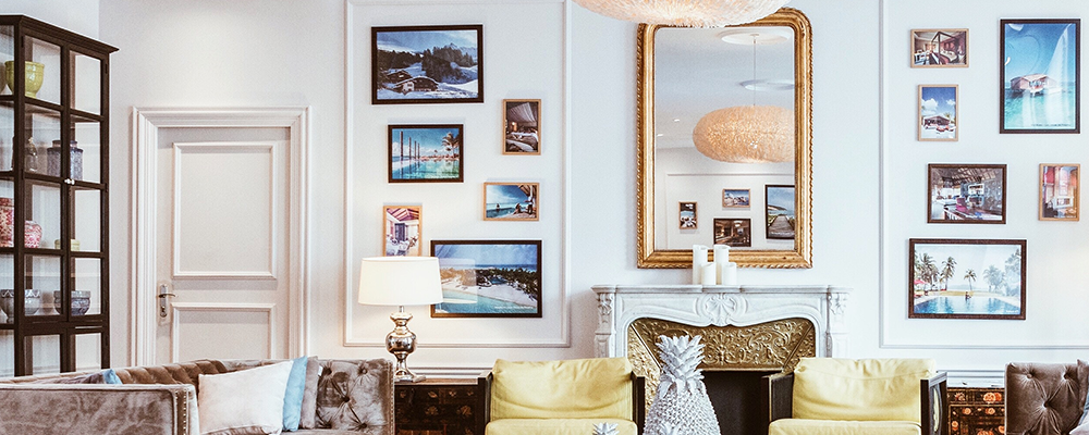 Wide angle of white accent wall with framed pictures in a gallery style