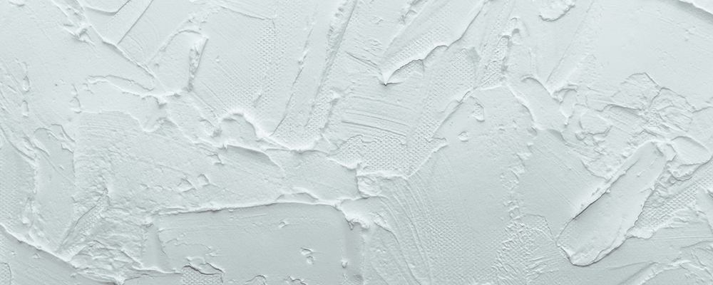 Closeup of textured drywall/plaster wall finish