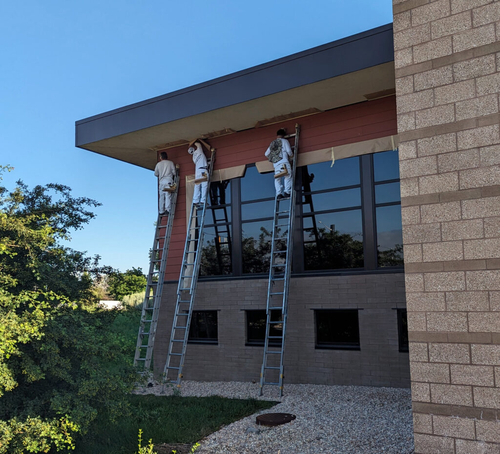 Exterior of the Anythink Library in Adams County Colorado being painted by Accent Painting company crew
