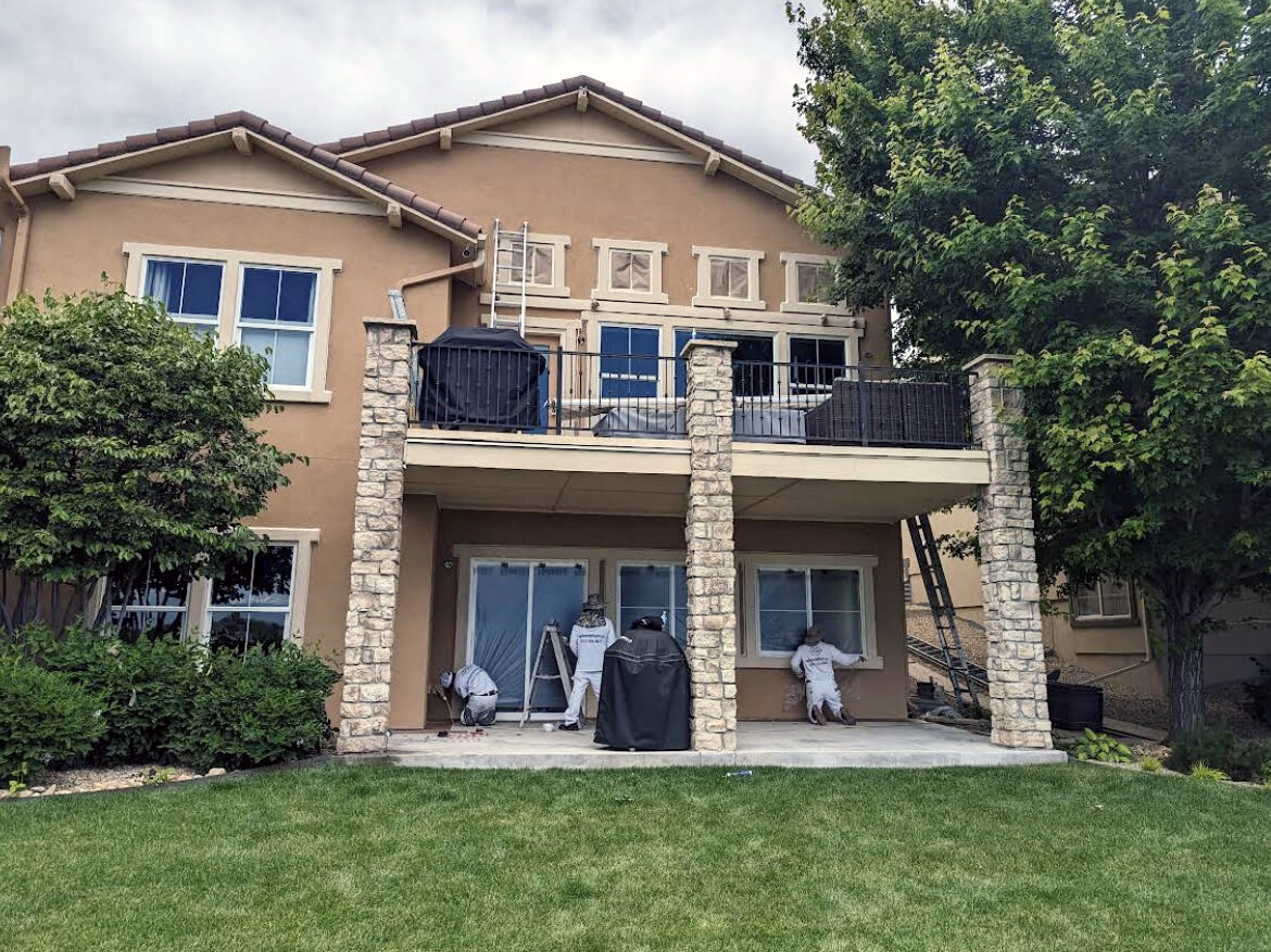 Professional painting service crew painting exterior of home in Arvada, CO