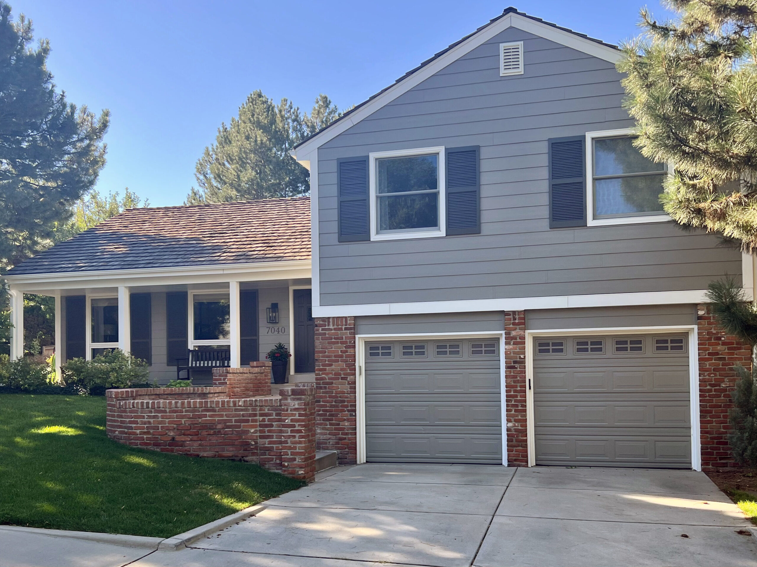 Front of four bedroom, two bathroom home with grey painted exterior