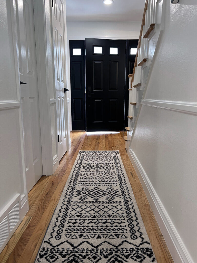 Trendy black door and hallway of new home remodel
